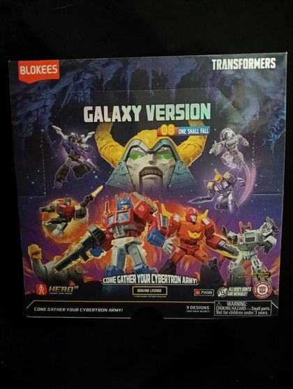 (OPTIMUS PRIME, HOT ROD, METROPLEX, SLUDGE, BLITZWING, SHRAPNEL, SHARKTIKON, UNICRON HEAD) TRANSFORMERS GALAXY VERSION 08: ONE SHALL FALL BLOKEES Ed 2025